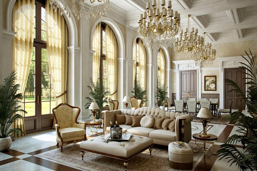 Просторный холл особняка в стиле luxury – дизайн украшен огромными хрустальными люстрами в симметрии, кессонными потолками, пастельными бежевыми красками и мягкой мебелью ручной работы